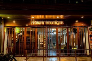Welcome to Honey Boutique, a charming building with a traditional facade and a warm entrance.