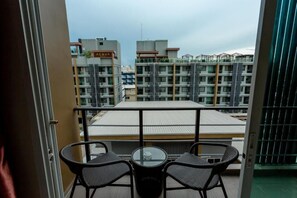 Enjoy a peaceful retreat with a balcony offering a view of the surrounding residential complex.