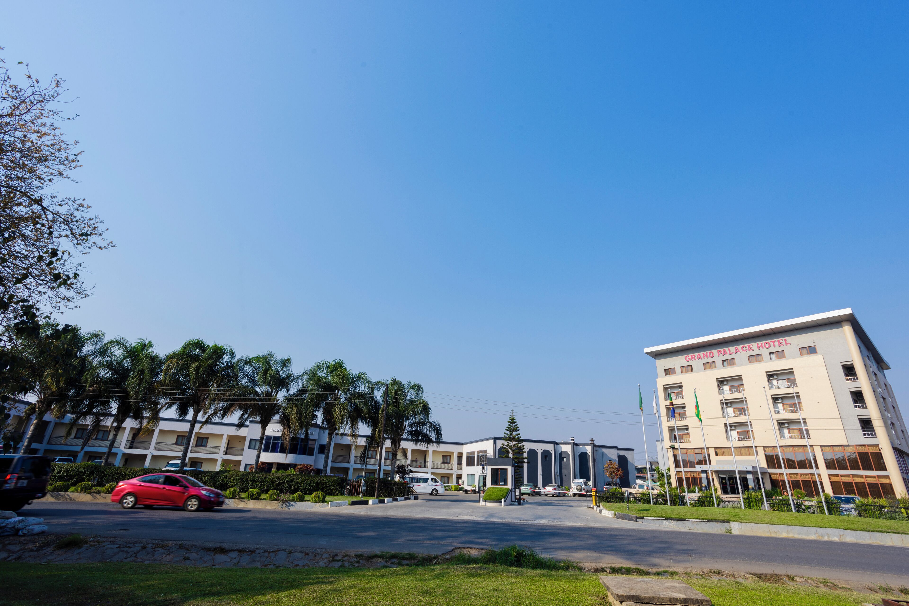 A hotel with a modern design, featuring multiple floors and a prominent entrance.