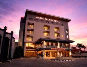 A multi-story hotel with a prominent sign reading 'Grand Palace Hotel.' - The Grand Palace Hotel (Lusaka)
