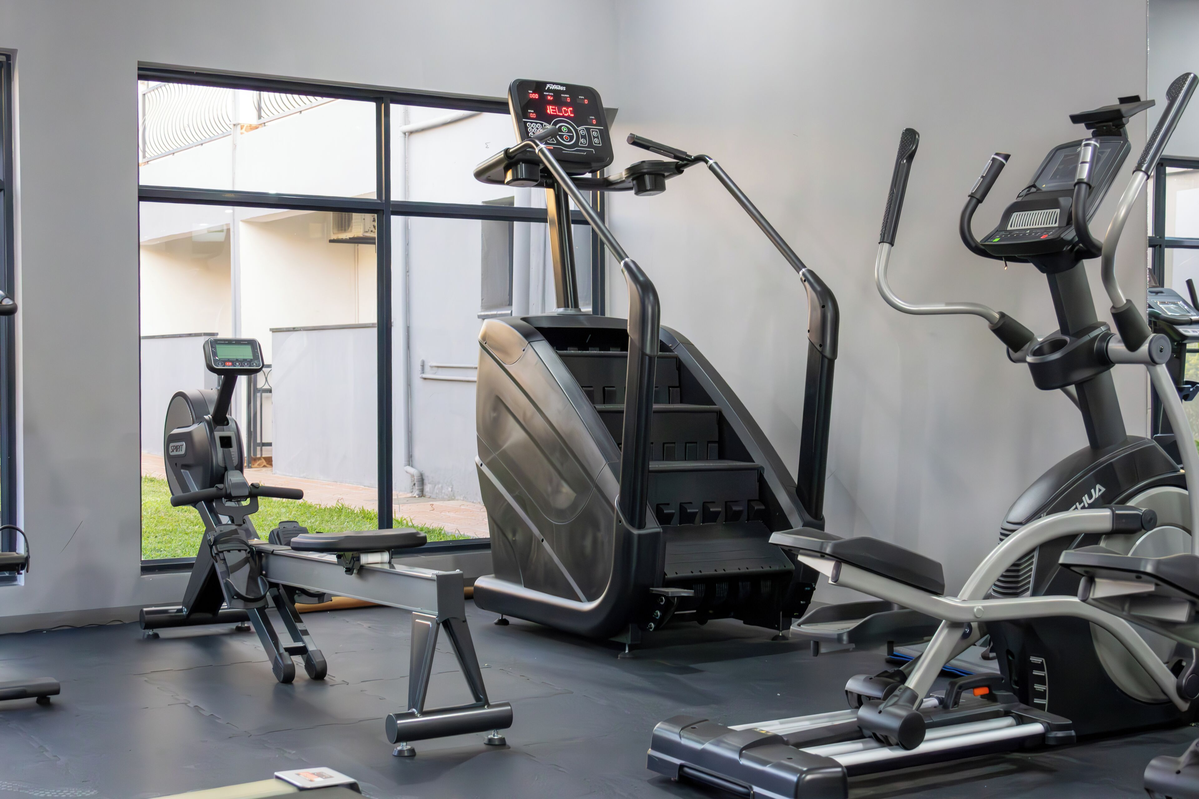 A gym with various exercise machines, a treadmill, and a stationary bike.