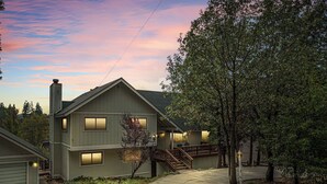A two-story house with a covered porch, a staircase, and a driveway. - Our Secret Getaway An Adventurer's Oasis (Lake Arrowhead)