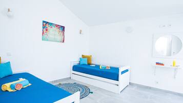 A modern bedroom with a bed, a smaller bed, a wall-mounted mirror, and a motivational poster.