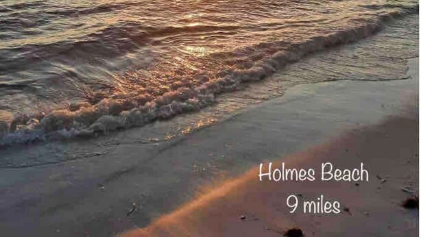 Holmes Beach with a pier extending into the water.