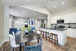 Enjoy meals in the kitchen with a central island and dining area featuring an oven and seating.