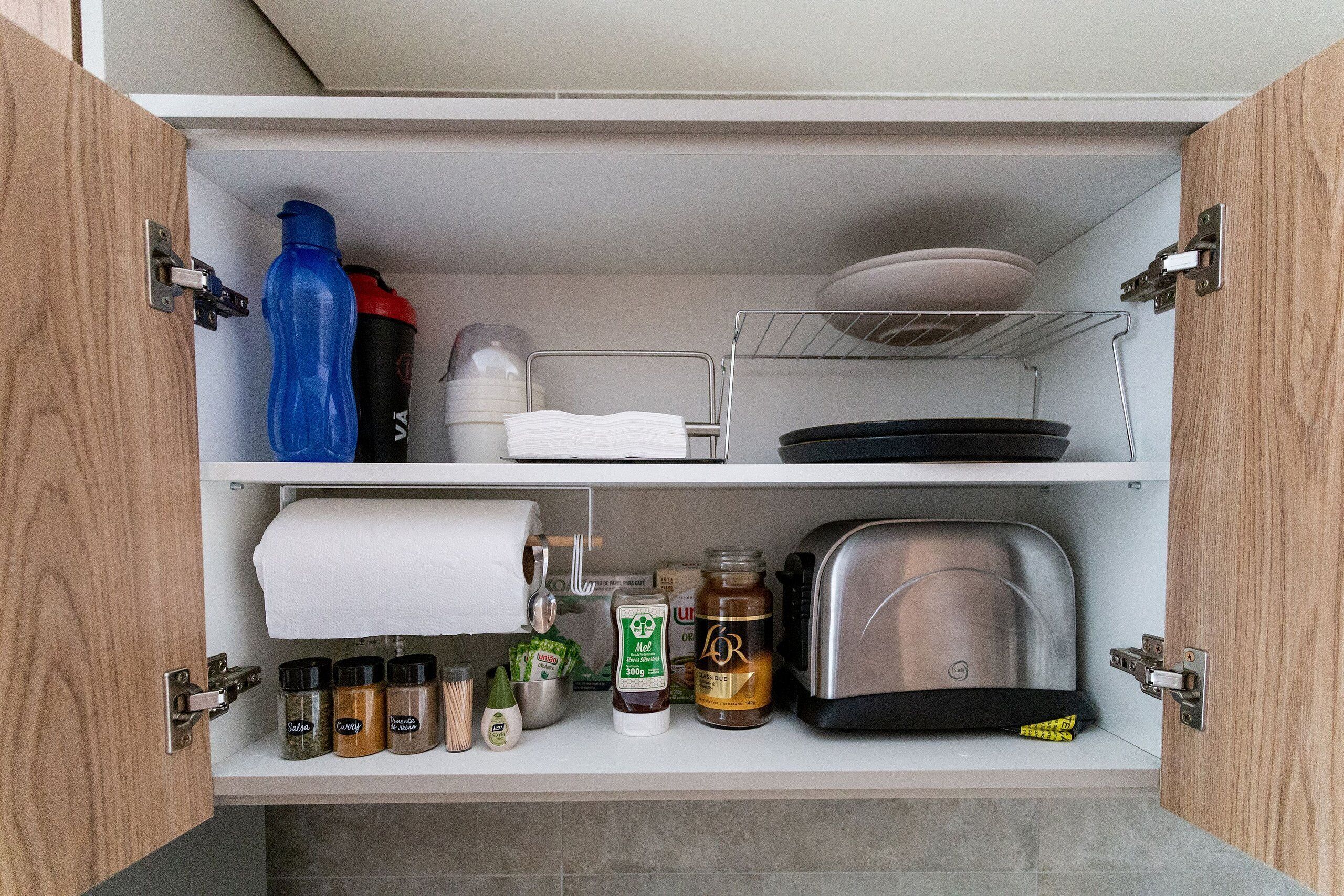 A kitchen pantry with shelves, a toaster, and various food items.