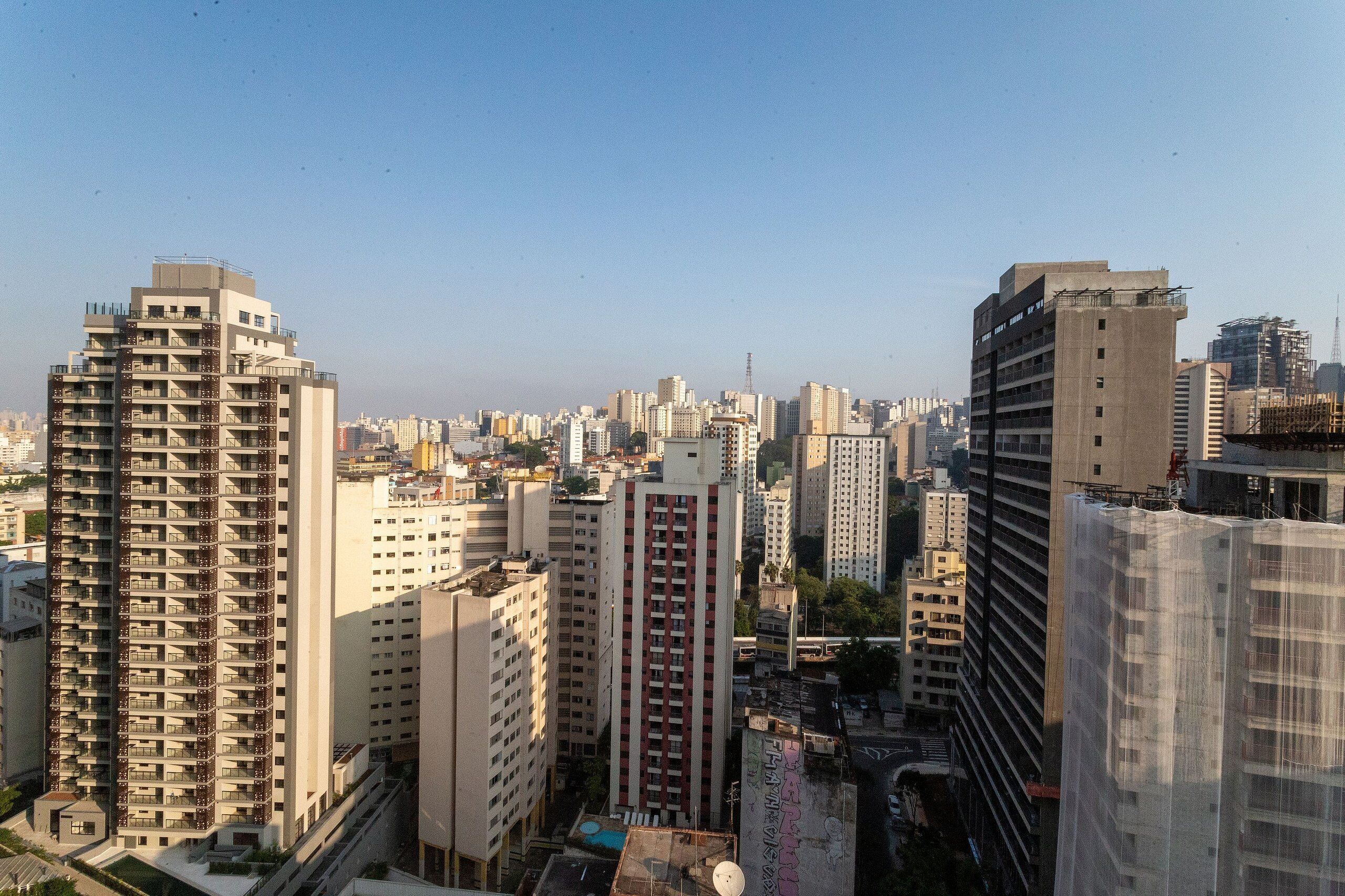 A high-rise building with multiple floors, surrounded by other tall buildings in an urban setting.