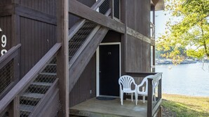 A wooden building with a staircase leading to a door marked '28'.