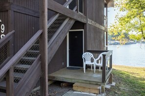A wooden building with a staircase leading to a door marked '28'. - Lone Oak Point 28 - Two Bedroom Apartment, Sleeps 6 (Sunrise Beach)