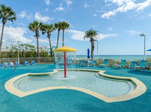 Relax by the pool surrounded by palm trees and lounge chairs.