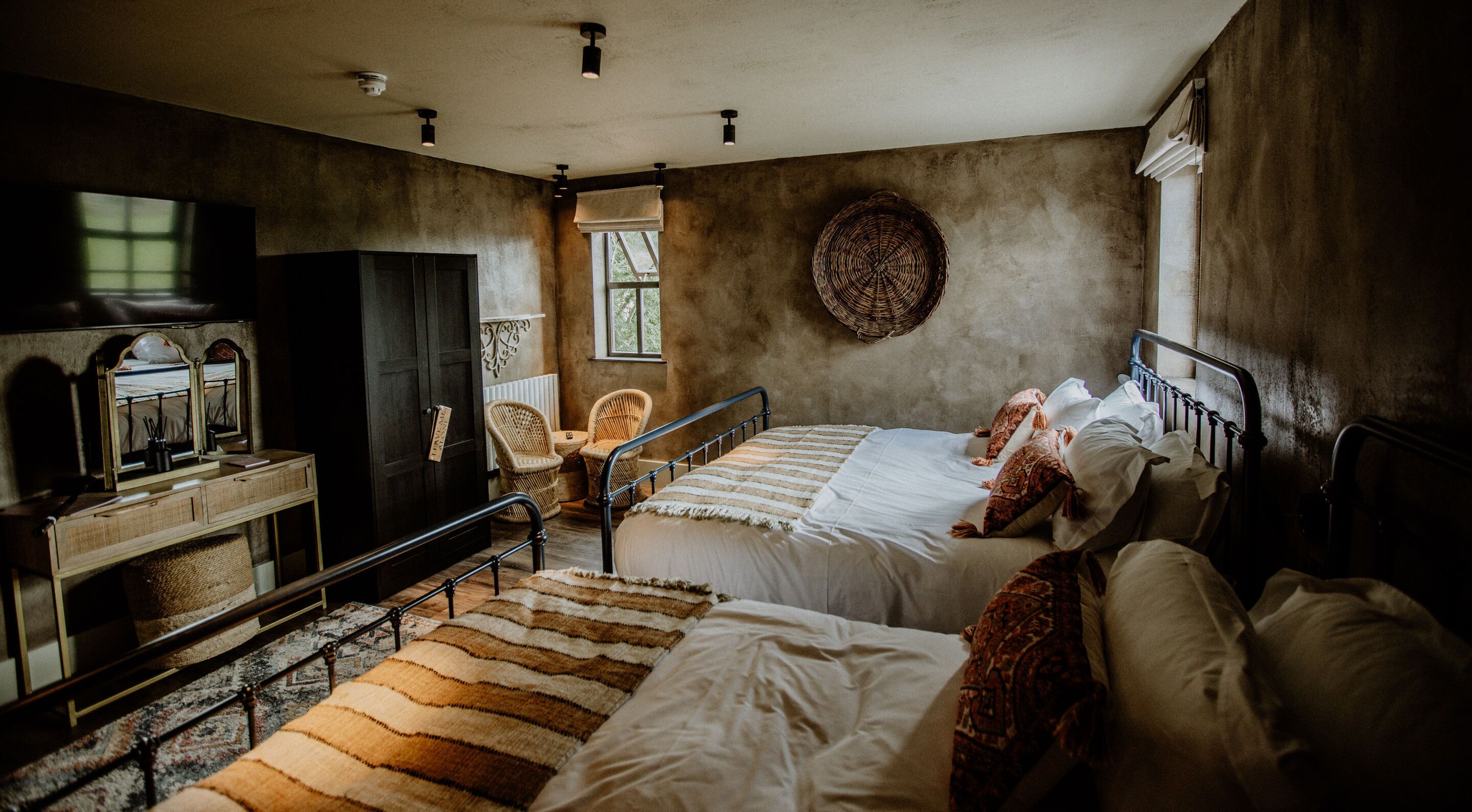 A bedroom with a bed, a dresser, a chair, and a window.