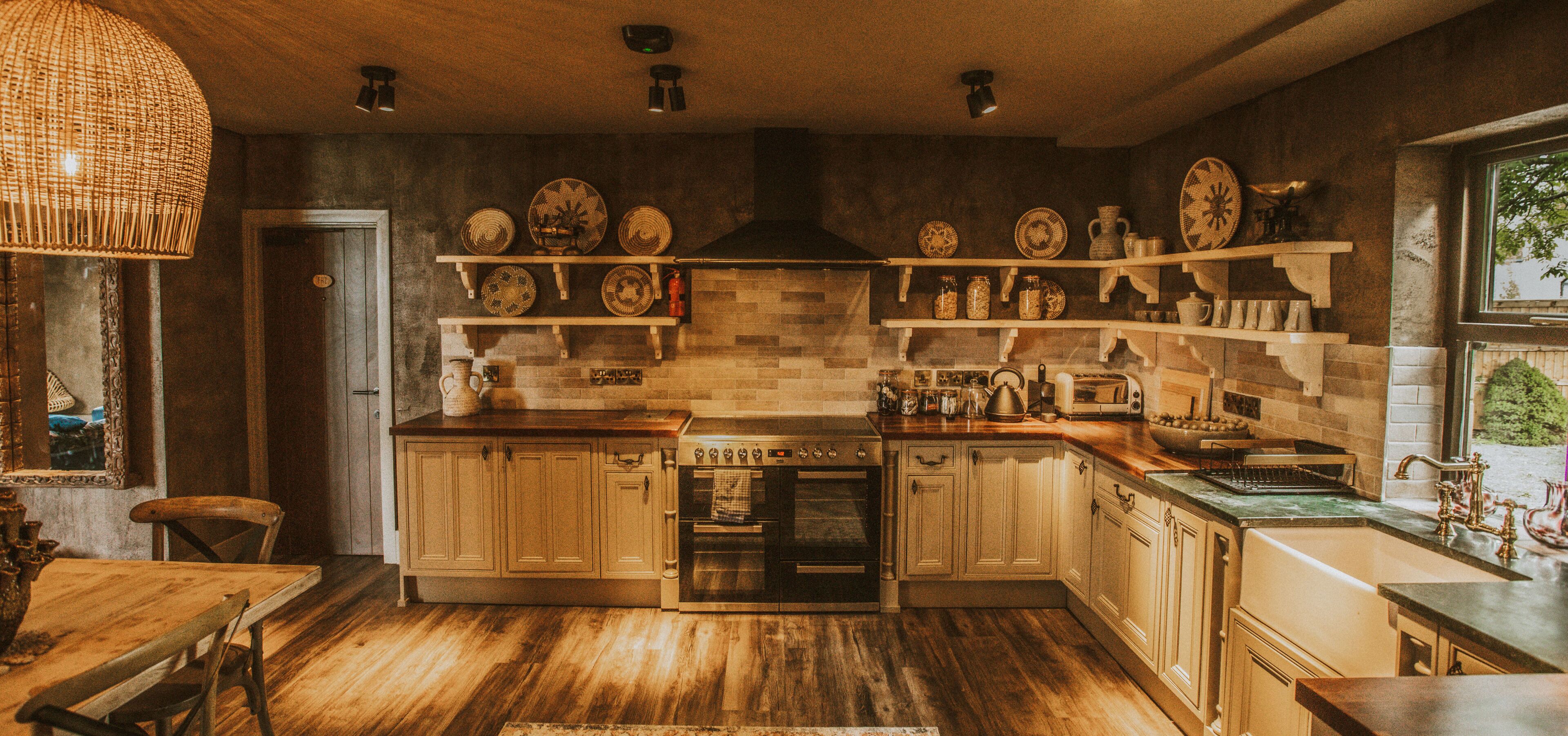 A kitchen with wooden cabinets, a built-in oven, and shelves with dishes.
