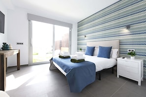 A modern hotel room with a bed, a bedside table, a nightstand, and a large window. - Salobre La Isla 8 (Maspalomas)