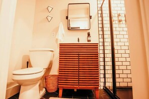 A bathroom with a toilet, wooden vanity, and a glass shower enclosure. - Spacious 4 bedroom Guest House with Hot Tub (Clare)