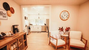 A modern kitchen with a coffee bar, wooden cabinets, and a clock on the wall. - Spacious 4 bedroom Guest House (Clare)