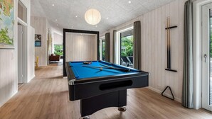 A pool table in a room with wooden floors and a ceiling with recessed lighting. - Gorgeous home in Oksbøl with sauna (Oksbøl)