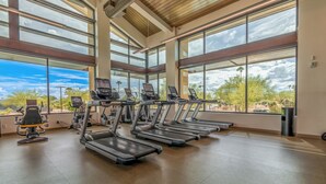 A gym with treadmills, exercise bikes, and a weight machine.