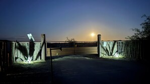 Ein durch einen Holzzaun und ein Metalltor abgegrenztes Grundstück mit einer Solaranlage.