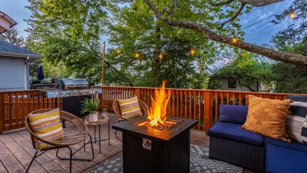 A deck with a square fire pit, wicker furniture, and a barbecue grill. - Completely Updated Home-sleeps 6-Centrally Located (Cincinnati)