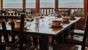 A restaurant with a wooden interior, large windows, and a view of mountains. - Luxury Cabin Awesome Mountain Views Sleeps 42 (Sevierville)