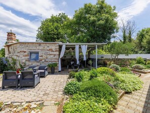 A stone building with a covered patio, outdoor seating, and a garden. - Stunning private villa for 8 people with private pool, A/C, WIFI, TV, terrace and pets allowed (Pazin)