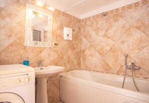 Bathtub, hair dryer, towels