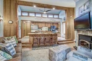 Relax in this spacious living area with a high ceiling and central island, perfect for casual dining or socializing.