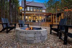 A two-story house with a deck and a fire pit in the foreground. - Games, Hot Tub, Fire Pit, Close to Town, Pets, Triple C (Broken Bow)