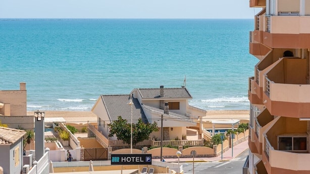 Ein Hotel mit Blick auf Strand und Meer.