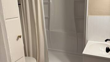 Combined shower/bathtub, towels, toilet paper