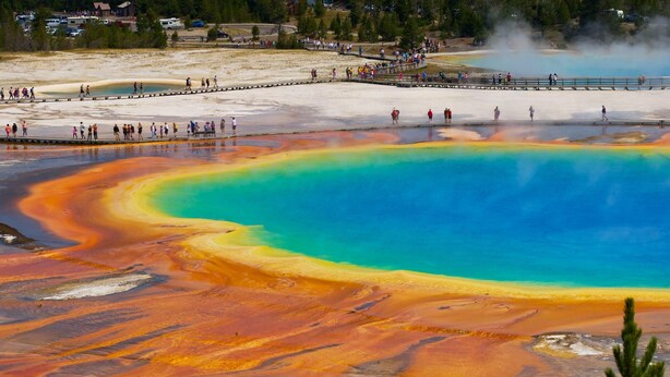 A large, colorful geothermal pool with visitors around it. - Paradise in Island Park! -Best location in Island Park 22 Miles from Yellowstone (Island Park)