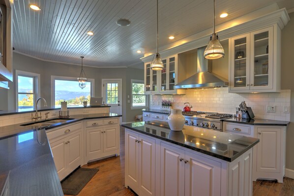 Enjoy cooking in this well-lit kitchen with a large island, stove, and oven.