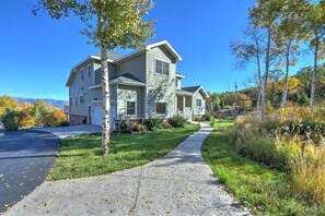 Stroll up the paved driveway to this charming two-story home, surrounded by lush trees and a beautifully manicured lawn.