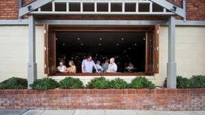 A restaurant with a brick facade, large windows, and a covered outdoor seating area. - The George Hotel (Bathurst)