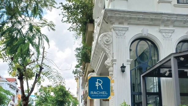 A serviced apartment building with a sign indicating 'Rachel Serviced Apartment'.