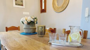 A wooden dining table with a pitcher of lemonade and glasses on a tray. - Relax with the whole family at this peaceful place to stay. (tzemi)