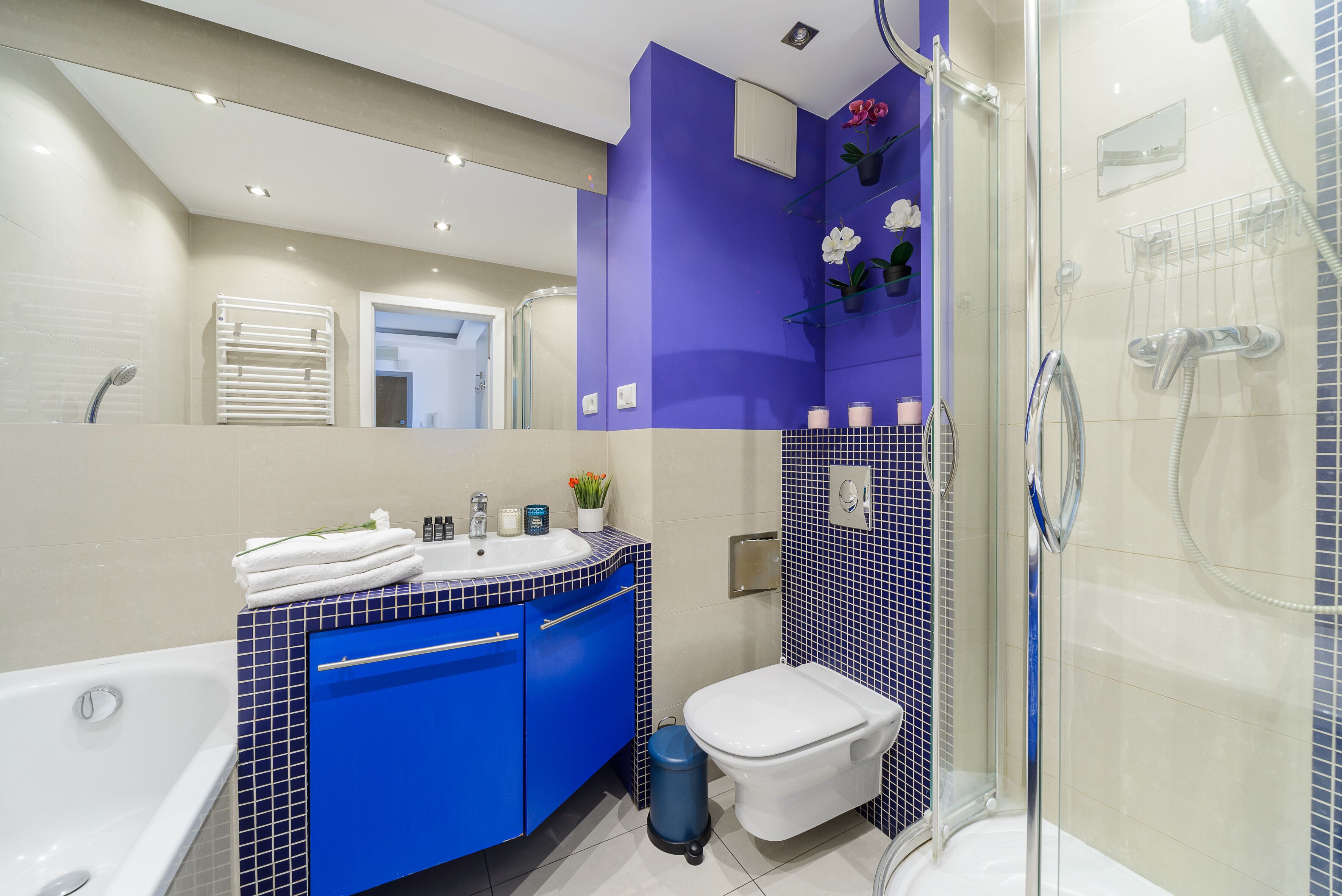 A modern bathroom with a bathtub, a sink, and a toilet.