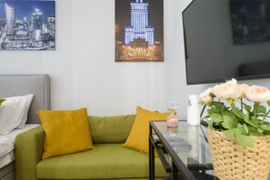 Relax in this stylish living room with a sofa, coffee table, and flat-screen TV.
