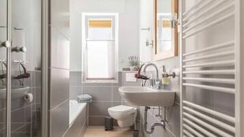 Bathtub, hair dryer, towels, soap