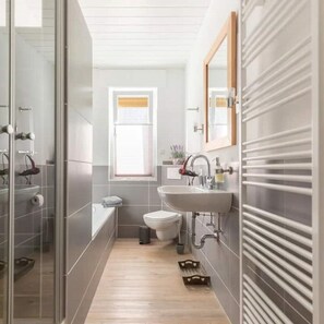 Bathtub, hair dryer, towels, soap