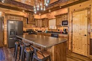 Enjoy cooking in this well-equipped kitchen with a central island and bar stools.