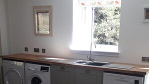 A laundry room with a washing machine, dryer, and dishwasher. - Lovely House Near Loch Ness in Scotland, UK (Inverness)