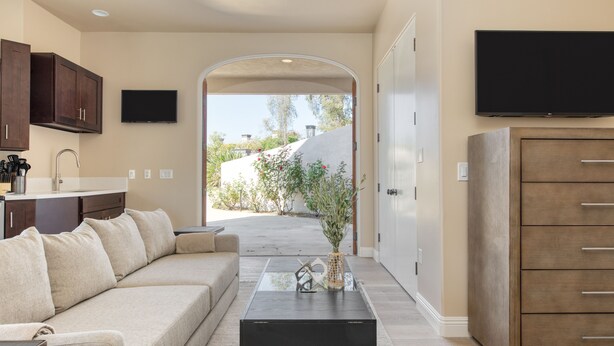 A modern living room with a sofa, coffee table, and TV.