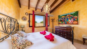 A bedroom with a bed, a chandelier, a painting, and a wooden ceiling. - Pet-Friendly "Finca Pep" with Pool & Wi-Fi (Sineu)
