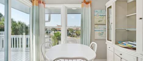 Enjoy a room with a balcony, a round dining table, and a convenient cabinet for storage.