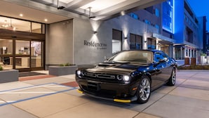 A black car parked in front of a hotel entrance with a sign reading "Residence Inn by Marriott." - Residence Inn by Marriott San Francisco Airport Millbrae Station (Millbrae)