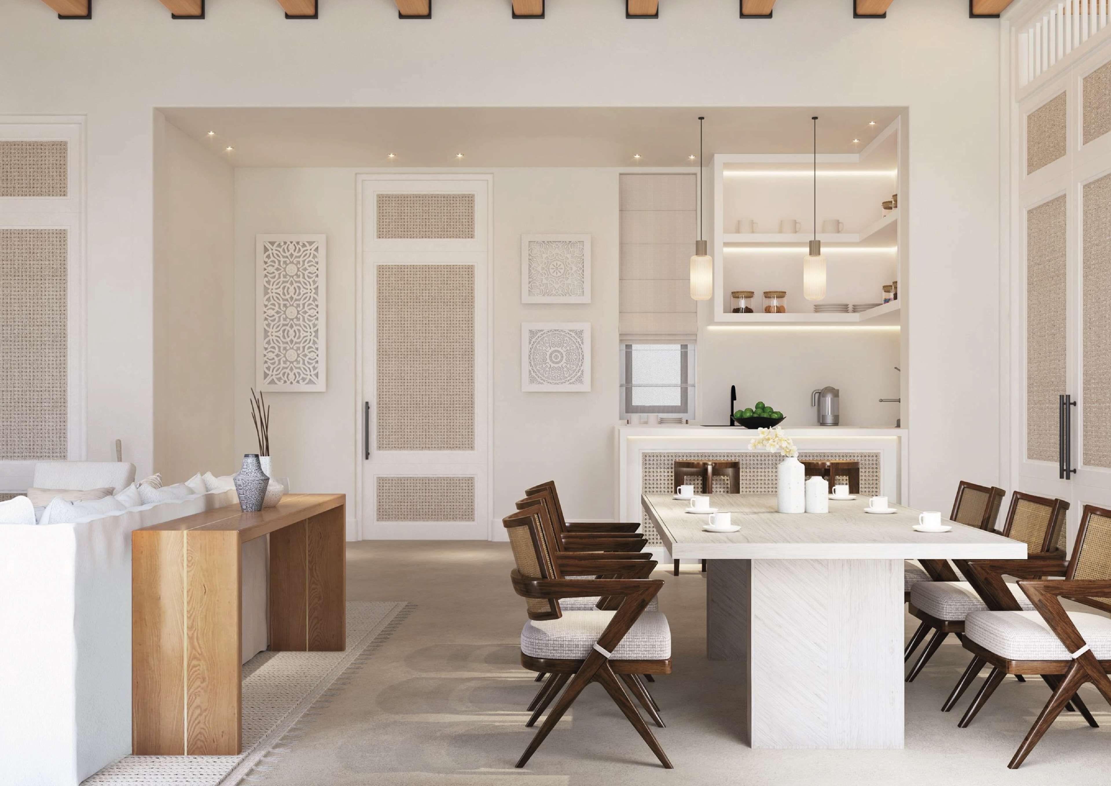 A modern kitchen with a dining area, featuring a large island, wooden chairs, and pendant lighting.