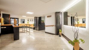 A modern hotel lobby with a reception desk, a staircase, and a reception area. - Plaza España 4BD / 2BTH with terrace (Barcelona)