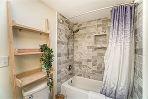 Combined shower/bathtub, hair dryer, towels, soap