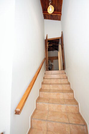 A staircase with wooden handrails and a light fixture above. - Villa with a private pool in Tela! Azalea House (Tela)
